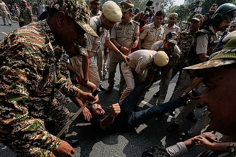 Police detain protesters during a demonstration demanding the resignation of Chief Election Commissioner Gyanesh Kumar in New Delhi, India, Saturday, Oct. 10, 2026.