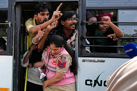 Protesters shout slogans from a police vehicle after being detained during a demonstration demanding the resignation of Chief Election Commissioner Gyanesh Kumar in New Delhi, India, Saturday, Oct. 10, 2026.