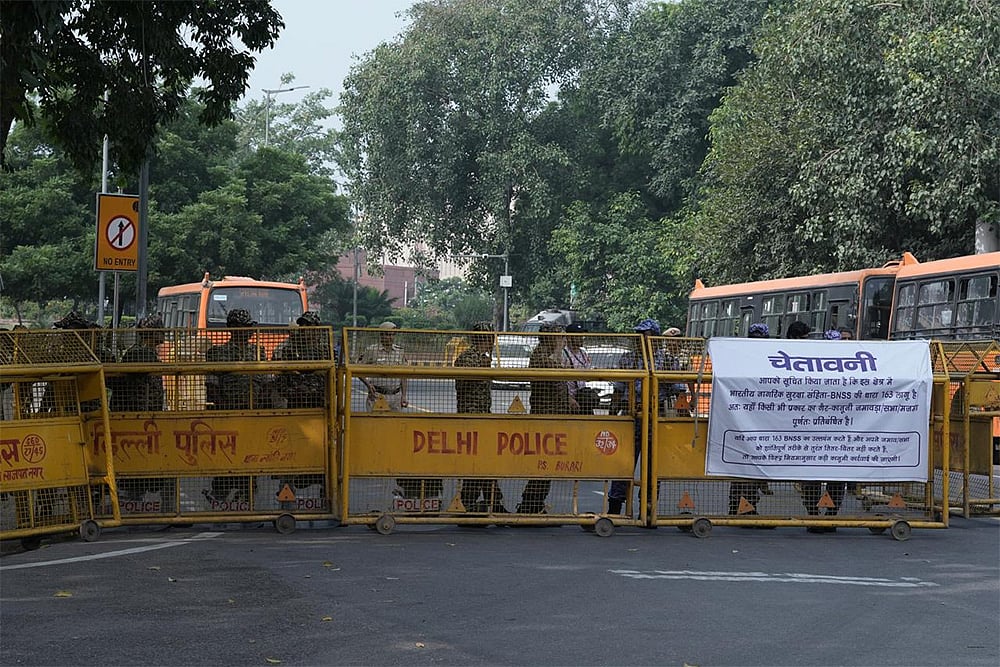 | Photo: Tribhuvan Tiwari : Security personnel stand guard and inspect as heavy police deployment and entry restrictions are enforced ahead of a planned protest by Cockroach Janta Party (CJP) members against Chief Election Commissioner (CEC) Gyanesh Kumar, in New Delhi