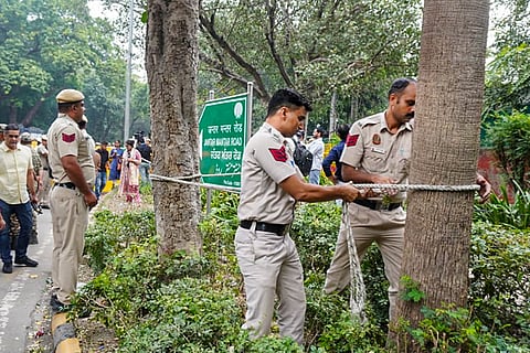 Security personnel keep vigil near Jantar Mantar as heavy police deployment and entry restrictions are enforced ahead of a planned protest by Cockroach Janta Party (CJP) members, in New Delhi, Saturday, Oct. 10, 2026.