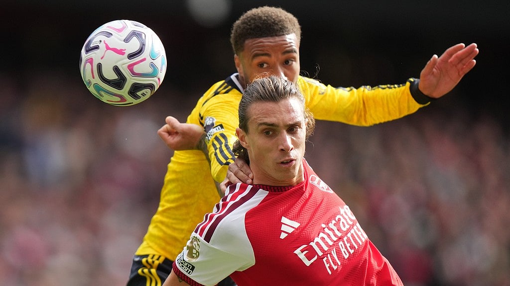 Arsenal's Riccardo Calafiori, right, challenges for the ball with Leeds' Jayden Bogle during the English Premier League soccer match between Arsenal and Leeds United in London, Saturday. - Alastair Grant/AP Photo