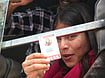Satyam Mishra  : Woman journalist shows press card while detained on a Delhi Police bus.
