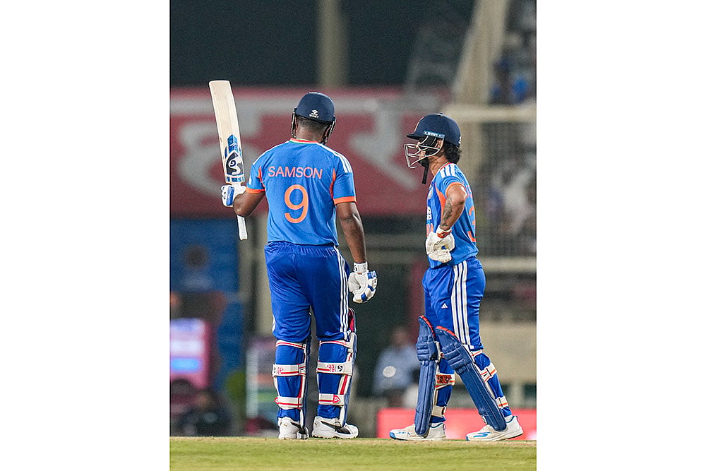 Indias Sanju Samson, left, celebrates his half century