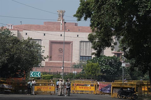 Security personnel stand guard and inspect as heavy police deployment and entry restrictions are enforced ahead of a planned protest by Cockroach Janta Party (CJP) members against Chief Election Commissioner (CEC) Gyanesh Kumar, in New Delhi.