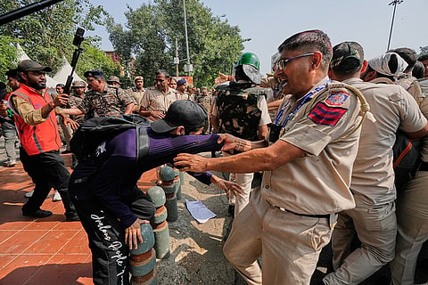 Police detain protesters during a demonstration demanding the resignation of Chief Election Commissioner Gyanesh Kumar in New Delhi, India, Saturday, Oct. 10, 2026.