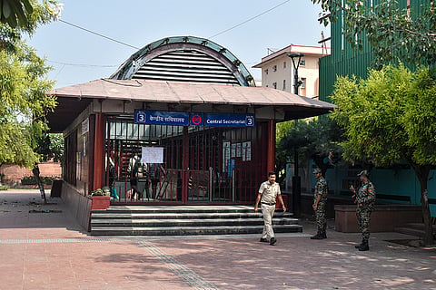 Security personnel stand guard outside the closed entry gates of Central Secretariat Metro station as heavy police deployment and entry restrictions are enforced ahead of a planned protest by Cockroach Janta Party (CJP) members, in New Delhi.