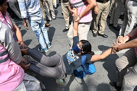 Police personnel detain a protester during a youth demonstration demanding the resignation of the country's election chief Gyanesh Kumar, in New Delhi, India, Saturday, Oct. 10, 2026.