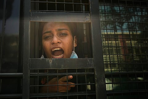 A protester shouts slogans from a police vehicle after being detained during a demonstration demanding the resignation of Chief Election Commissioner Gyanesh Kumar in New Delhi, India, Saturday, Oct. 10, 2026.