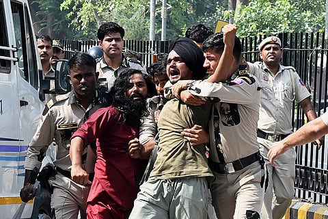 Policemen detain protesters during a youth demonstration demanding the resignation of the country's election chief Gyanesh Kumar, in New Delhi, India, Saturday, Oct. 10, 2026.