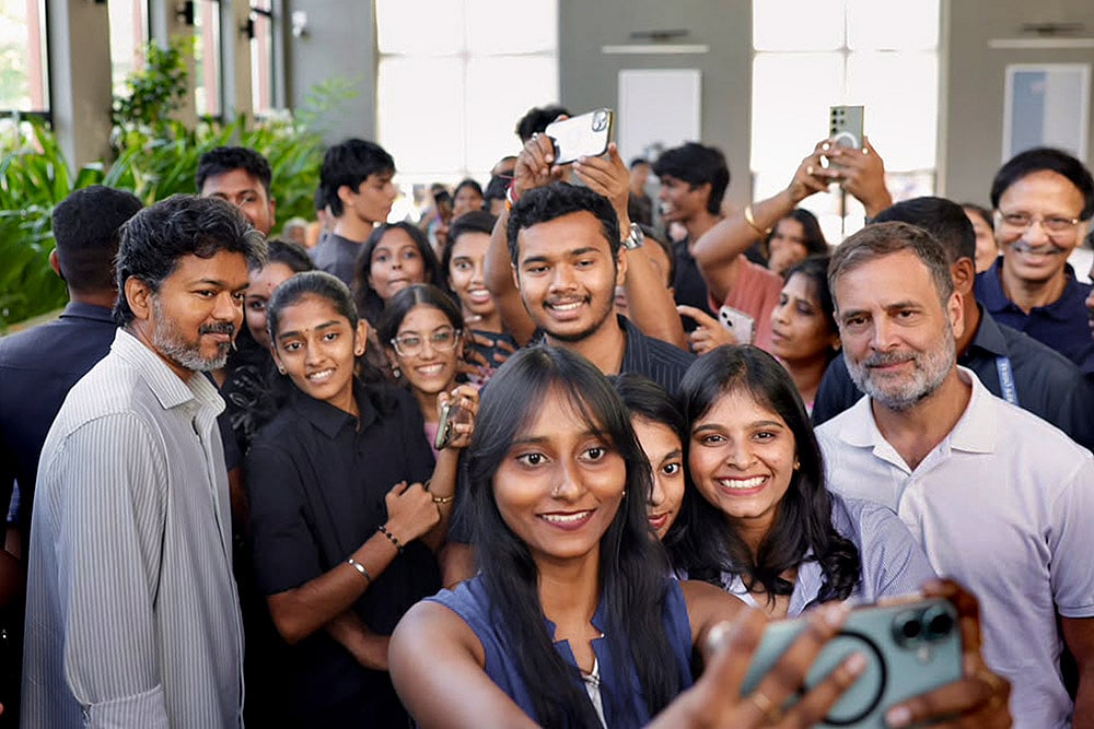In this image released on Oct. 10, 2026, Tamil Nadu Chief Minister Vijay and Congress leader and LoP in the lok Sabha Rahul Gandhi clicks selfies with people during a meeting, in Chennai. - | Photo: AICC via PTI 