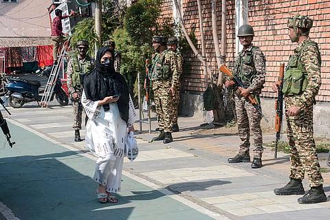Security personnel stand guard near a blocked road close to the Congress headquarters ahead of an INDIA bloc protest against Chief Election Commissioner Gyanesh Kumar, in Srinagar, Jammu and Kashmir.