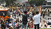 | Photo: PTI/Rushikesh More : Demonstrators raise slogans as security personnel stand guard in Connaught Place during a protest organised by the Cockroach Janta Party (CJP) demanding the resignation of Chief Election Commissioner (CEC) Gyanesh Kumar over alleged electoral roll irregularities, in New Delhi.