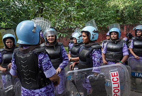 Security personnel stand guard near Pt. Ravi Shankar Shukla Lane amid heightened security arrangements during a protest by Cockroach Janta Party (CJP) against Chief Election Commissioner (CEC) Gyanesh Kumar over alleged electoral roll irregularities, in New Delhi, Saturday, Oct. 10, 2026. 
