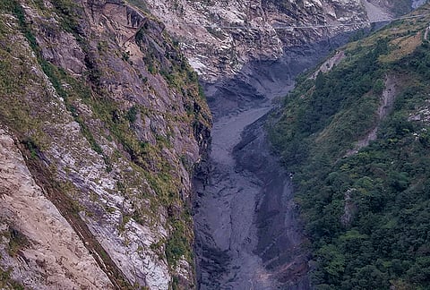 An aerial view shows mudslide debris and floodwaters overflowing the Budhi Gandaki river following a sudden flash flood triggered by a suspected landslide in the Chekampar area, in Gorkha district, Nepal, Sunday, Oct. 11, 2026.  
