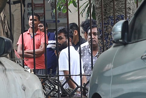 Abhijeet Dipke, center, founder of the Cockroach Janta Party, stands on the court premises following his release in New Delhi.