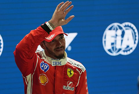 Ferrari driver Lewis Hamilton of Britain waves after competing in the qualifying session ahead of the Singapore Formula One Grand Prix in Singapore, Saturday, Oct. 10, 2026. 