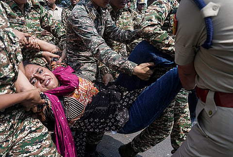 Security personnel detain a demonstrator during a protest call by Cockroach Janta Party (CJP) against Chief Election Commissioner (CEC) Gyanesh Kumar over alleged electoral roll irregularities, in New Delhi, Saturday, Oct. 10, 2026. 
