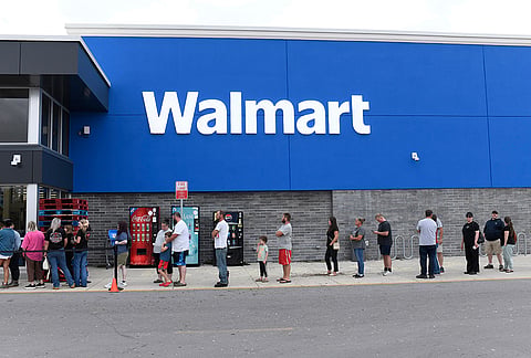 People wait in line to enter a Walmart in on Saturday, Oct. 10, 2026, in Milton, Florida. 
