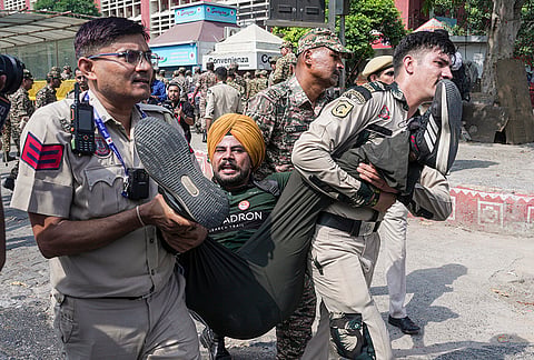 Security personnel detain a demonstrator during a protest call by Cockroach Janta Party (CJP) against Chief Election Commissioner (CEC) Gyanesh Kumar over alleged electoral roll irregularities, in New Delhi, Saturday, Oct. 10, 2026. 
