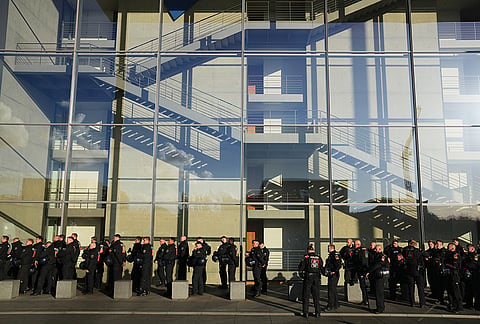 Police officers guard as Pro-Palestinian protesters marsh during a rally in Berlin, Germany, Saturday, Oct. 10, 2026. 
