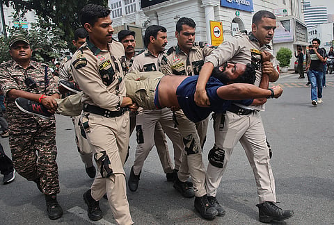 Police detain a protester during a demosntrationt demanding the resignation of Chief Election Commissioner Gyanesh Kumar during a protest in New Delhi, India, Sunday, Oct. 11, 2026. 