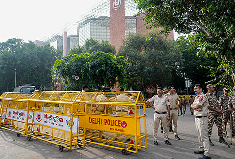 Security personnel stand guard and place barricades along the Outer Circle of Connaught Place to restrict vehicular and pedestrian movement following continued demonstration calls by the Cockroach Janta Party (CJP) demanding the resignation of Chief Election Commissioner (CEC) Gyanesh Kumar, in New Delhi. 