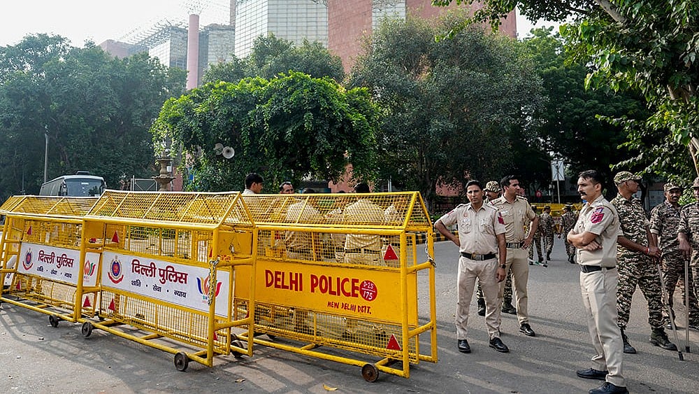 Security personnel stand guard and place barricades along the Outer Circle of Connaught Place to restrict vehicular and pedestrian movement following continued demonstration calls by the Cockroach Janta Party (CJP)  - | Photo: PTI/Salman Ali