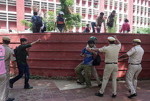 Security personnel detain a demonstrator during an agitation by Cockroach Janta Party (CJP) against Chief Election Commissioner (CEC) Gyanesh Kumar over alleged electoral roll irregularities, in New Delhi, Saturday, Oct. 10, 2026. 

