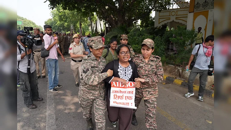 Police personnel detain a protester - Outlook| Suresh Pandey