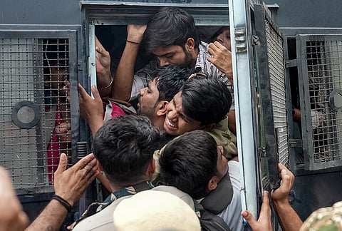 Police personnel detain protestors amid continued demonstration calls by the Cockroach Janta Party (CJP) demanding the resignation of Chief Election Commissioner (CEC) Gyanesh Kumar, in Connaught Place area, New Delhi, Sunday, Oct. 11, 2026. 
