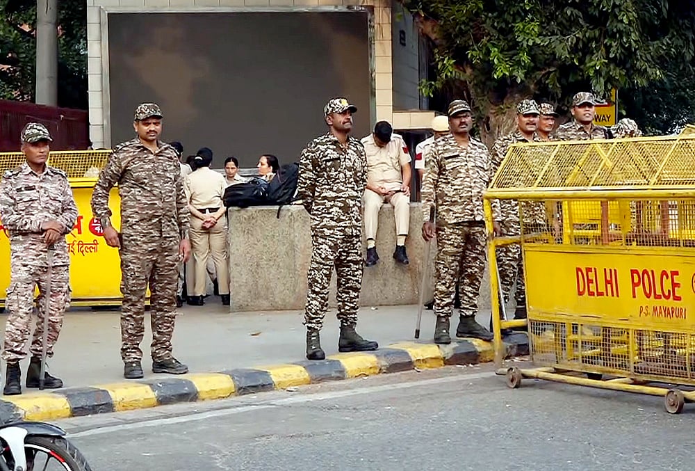 Security personnel stand guard and place barricades along the Outer Circle of Connaught Place to restrict vehicular and pedestrian movement following continued demonstration calls by the Cockroach Janta Party (CJP) demanding the resignation of Chief Election Commissioner (CEC) Gyanesh Kumar, in New Delhi, Sunday, Oct. 11, 2026. 