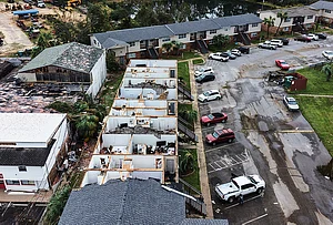 | Photo: AP/Gerald Herbert : An apartment complex which had its roof ripped off is seen in the aftermath of Hurricane Isaias in Milton, Fla., Saturday, Oct. 10, 2026.