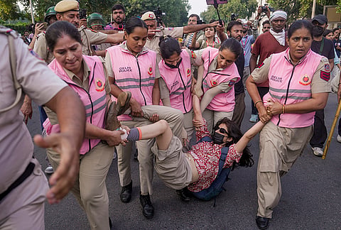 Police personnel detain a woman activist during a demonstration call by the Cockroach Janta Party (CJP) demanding the resignation of Chief Election Commissioner (CEC) Gyanesh Kumar over alleged electoral roll irregularities, at Connaught Place, in New Delhi, Saturday, Oct. 10, 2026. 
