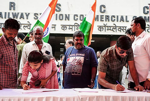 Maharashtra Navnirman Sena (MNS) workers and activists hold a signature campaign to demand the resignation of Chief Election Commissioner Gyanesh Kumar, outside the Vashi Railway Station Commercial Complex, in Navi Mumbai, Maharashtra.