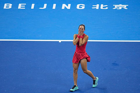 Zheng Qinwen, of China, celebrates after winning the women's singles final match against a Mirra Andreeva, of Russia at the China Open tennis tournament in Beijing, Sunday, Oct. 11, 2026.