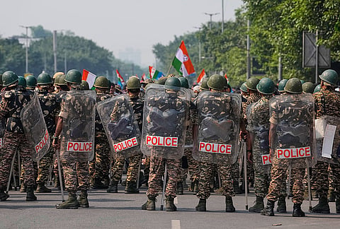 Security personnel in riot gear arrive to escort workers of India's opposition Congress party as they gather for a march toward the Supreme Court demanding the resignation of Chief Election Commissioner Gyanesh Kumar in New Delhi, India, Monday, Oct. 12, 2026. 