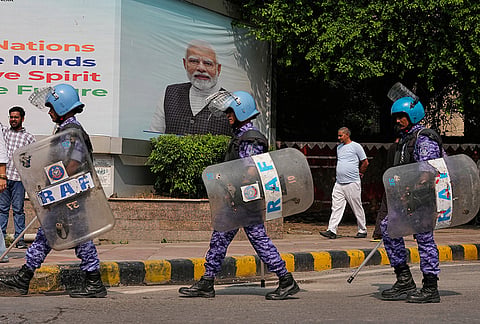 Security personnel in riot gear arrive to escort workers of India's opposition Congress party as they gather for a march toward the Supreme Court demanding the resignation of Chief Election Commissioner Gyanesh Kumar in New Delhi, India, Monday, Oct. 12, 2026.
