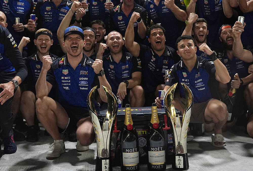 | Photo: AP/Ng Han Guan : Red Bull driver Max Verstappen of the Netherlands, center left celebrates with his team and teammate Isack Hadjar of France, center right after winning the Singapore Formula One Grand Prix race in Singapore, Sunday, Oct. 11, 2026. 