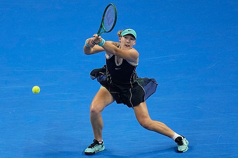 Mirra Andreeva, of Russia, returns a ball to Zheng Qinwen, of China during the women's singles final match at the China Open tennis tournament in Beijing, Sunday, Oct. 11, 2026.
