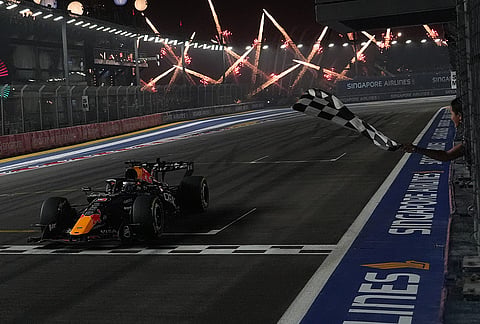 Red Bull driver Max Verstappen of the Netherlands crosses the finish line to win the Singapore Formula One Grand Prix race in Singapore, Sunday, Oct. 11, 2026. 