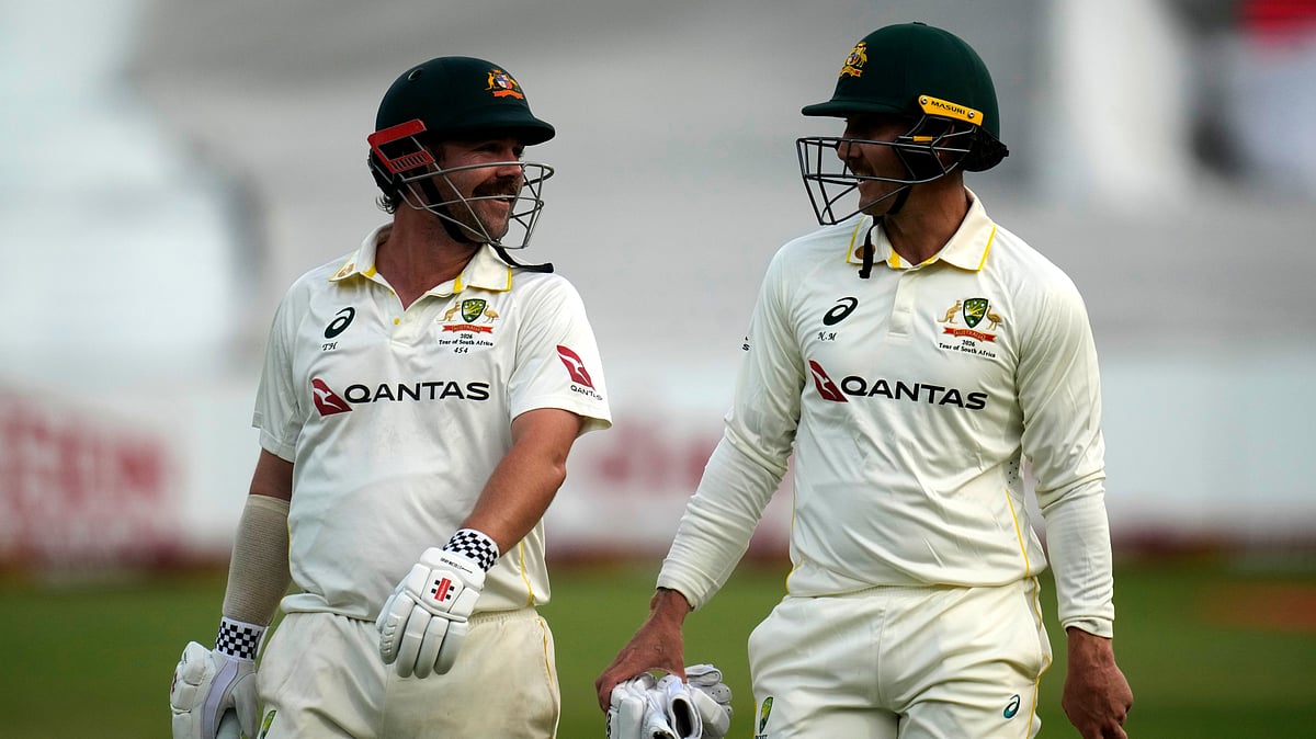Australia's Travis Head, left, and his teammate Nic Maddinson leave the field after play had being stopped due to bad light on day three of the first cricket test match between South Africa and Australia, in Durban, South Africa, Sunday, Oct. 11, 2026 - (AP Photo/Themba Hadebe)
