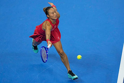 Zheng Qinwen, of China, returns a ball to Mirra Andreeva, of Russia during the women's singles final match at the China Open tennis tournament in Beijing, Sunday, Oct. 11, 2026.