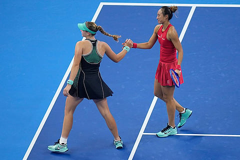 Zheng Qinwen, of China,right shake hands with Mirra Andreeva, of Russia after winning the women's singles final match at the China Open tennis tournament in Beijing, Sunday, Oct. 11, 2026.