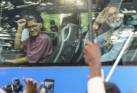 All India Students' Association (AISA) National President Neha Bora, activist Yogendra Yadav greet the supporters from a bus during ‘March for Democracy’ by INDIA bloc leaders to the Supreme Court, to file a petition against Chief Election Commissioner Gyanesh Kumar and 'vote chori', at Barakhamba road, in New Delhi, Monday, Oct. 12, 2026. 
