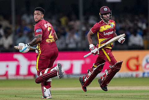 West Indies' Shimron Hetmyer, left, and Kamil Pooran run between the wickets during the third T20I cricket match of a series between India and West Indies, in Indore, Madhya Pradesh, Sunday, Oct. 11, 2026. 