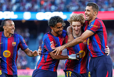 From left, Barcelona's Jules Kounde, Barcelona's Lamine Yamal, Barcelona's Anthony Gordon, Barcelona's Rodrigo celebrate after scoring during the Spanish La Liga soccer match between Barcelona and Getafe in Barcelona, Spain, Saturday, Oct. 10, 2026. 