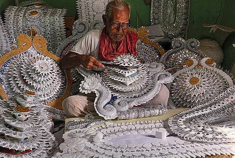 An elderly artisan works on ornaments for the idols of Goddess Durga for the ‘Durga Puja’ festival, in Birbhum, Thursday, Oct. 8, 2026. 
