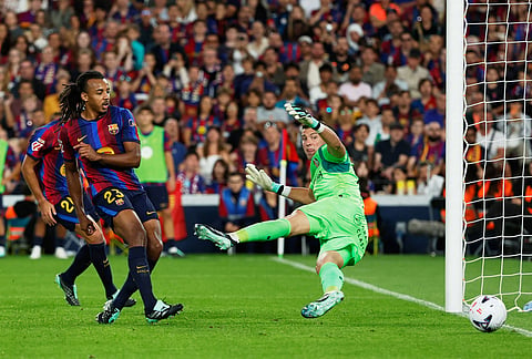 Barcelona's Jules Kounde, left, scores his side's third goal during the Spanish La Liga soccer match between Barcelona and Getafe in Barcelona, Spain, Saturday, Oct. 10, 2026. 

