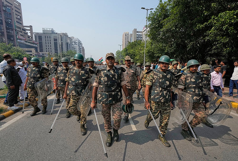 Security personnel escort workers of India's opposition Congress party as they gather for a march toward the Supreme Court demanding the resignation of Chief Election Commissioner Gyanesh Kumar in New Delhi, India, Monday, Oct. 12, 2026.  - | Photo: AP/Manish Swarup