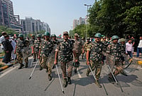 In Photos: Security Tightened Ahead Of Rahul Gandhi-led INDIA Bloc March To Supreme Court | Photo: AP/Manish Swarup : Security personnel escort workers of India's opposition Congress party as they gather for a march toward the Supreme Court demanding the resignation of Chief Election Commissioner Gyanesh Kumar in New Delhi, India, Monday, Oct. 12, 2026.